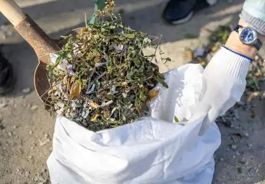 Green waste being collected into bags during mini skip bin hire launceston projects