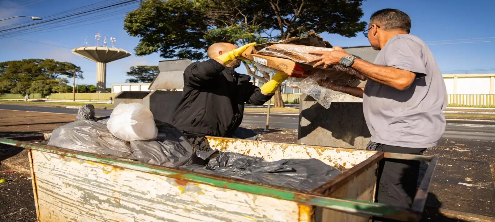 Workers unloading cleanup equipment for garden rubbish removal Launceston